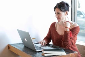 woman typing on laptop
